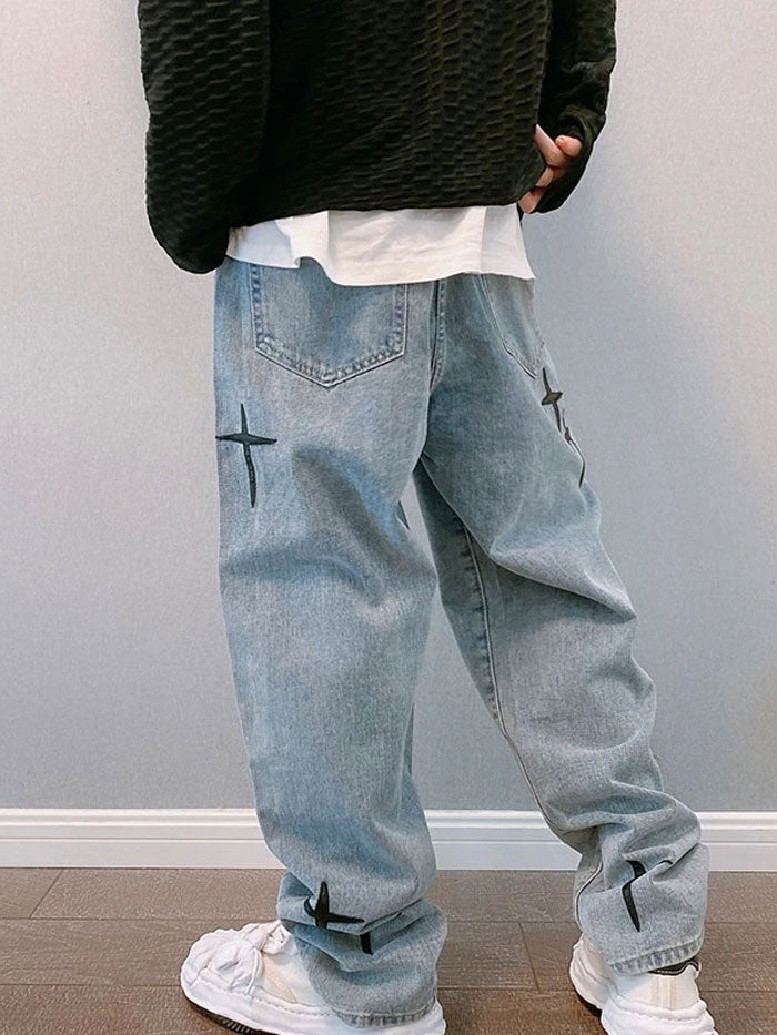 Rear view showcasing vintage-style denim jeans with cross embroidery