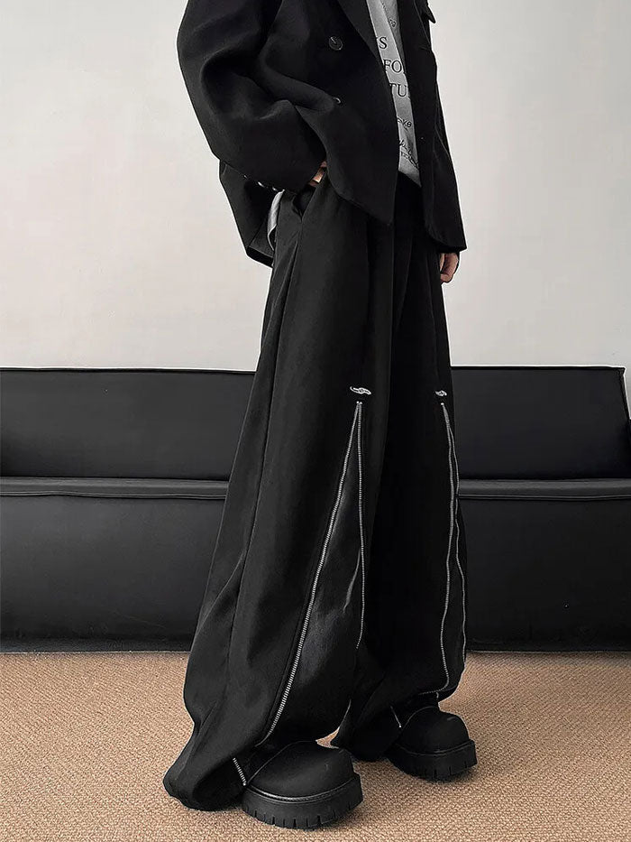 Full-frontal view of stylish black pants with vertical leather zipper designs.