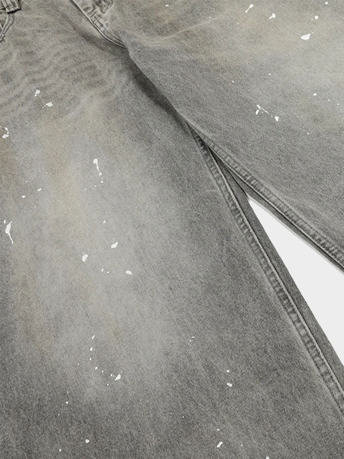 Side angle of model wearing ultra wide-leg grey jeans with a worn-in vintage finish.