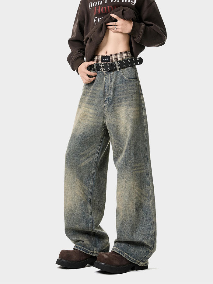 Side angle of vintage washed wide-leg jeans with relaxed fit and faded denim style.