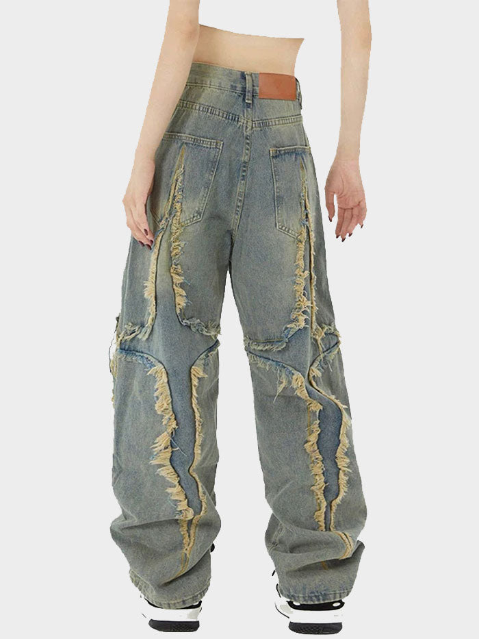 Side view of washed fringe jeans showcasing ripped seams and retro vibe.
