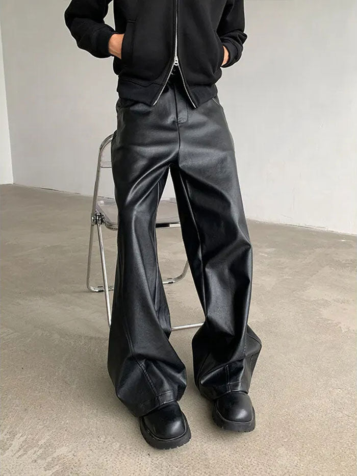 High-waisted oversized faux leather pants styled with hoodie.