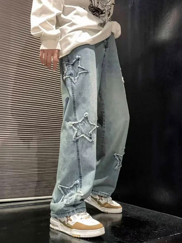 Light blue baggy jeans with frayed star patch details, worn with a white long-sleeve and stylish sneakers