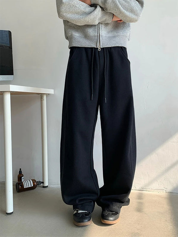 Black wide-leg sweatpants for men, front view with drawstring waist.