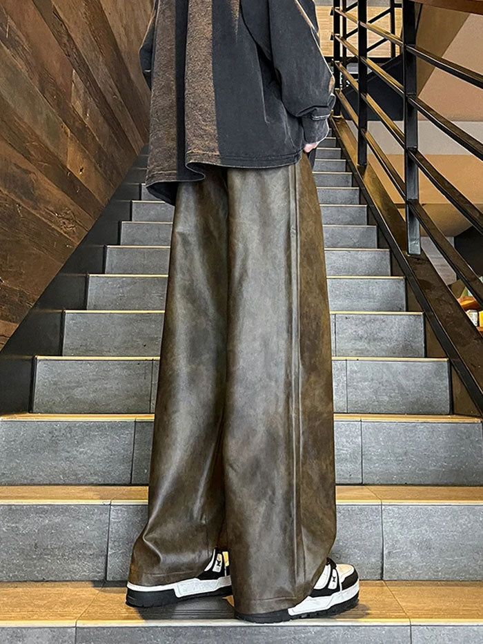 Back view of brown faux leather wide-leg trousers styled on staircase.