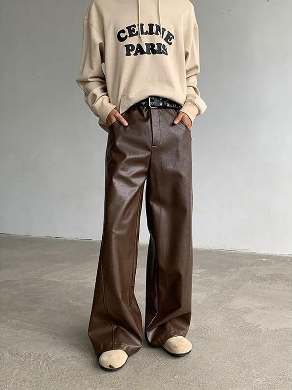 Brown faux leather pants with relaxed fit and beige sweater combo.