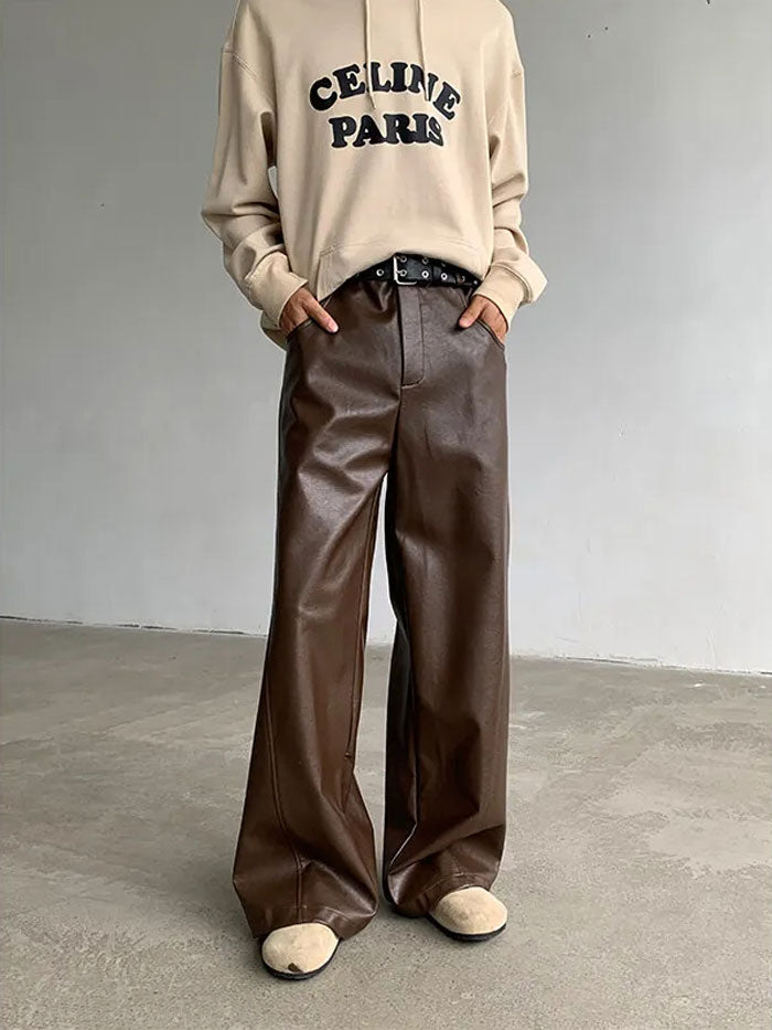Brown faux leather pants with relaxed fit and beige sweater combo.