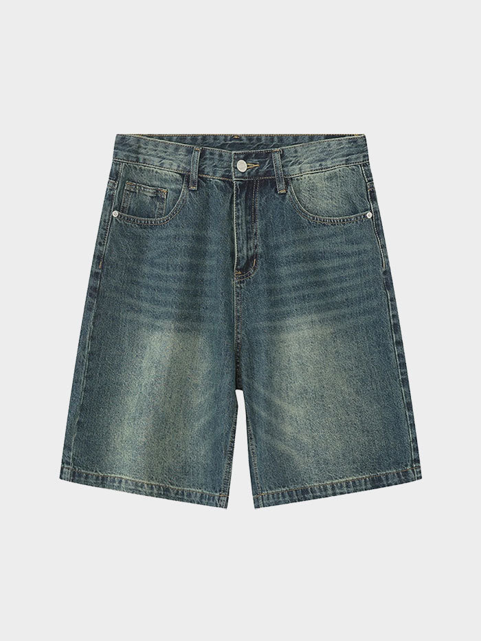 Flat lay of classic blue denim shorts with subtle fading and clean hems.