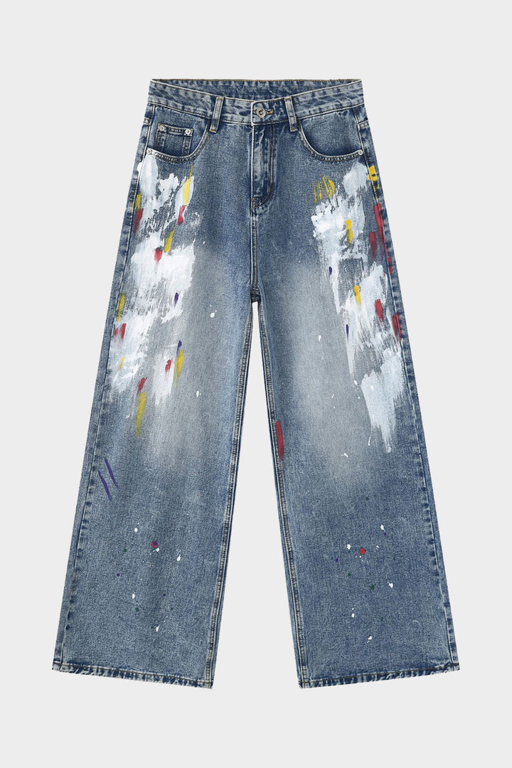 Flatlay image of paint-splattered wide-leg jeans in vintage blue