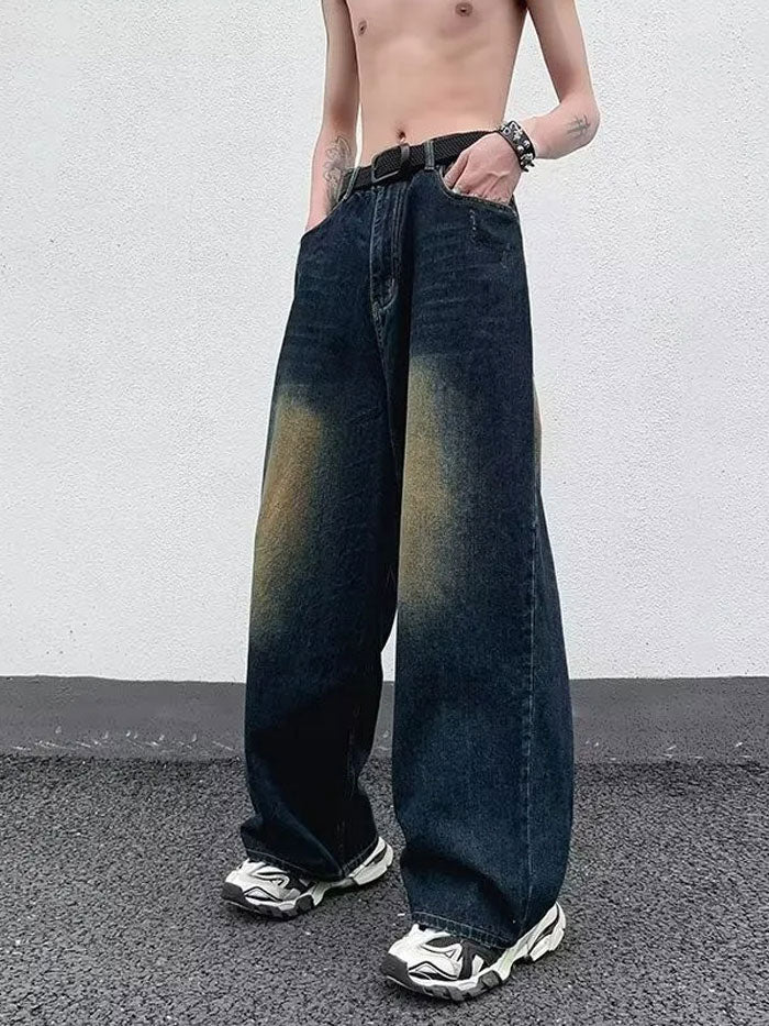 Distressed loose fit denim jeans paired with a casual men’s streetwear outfit