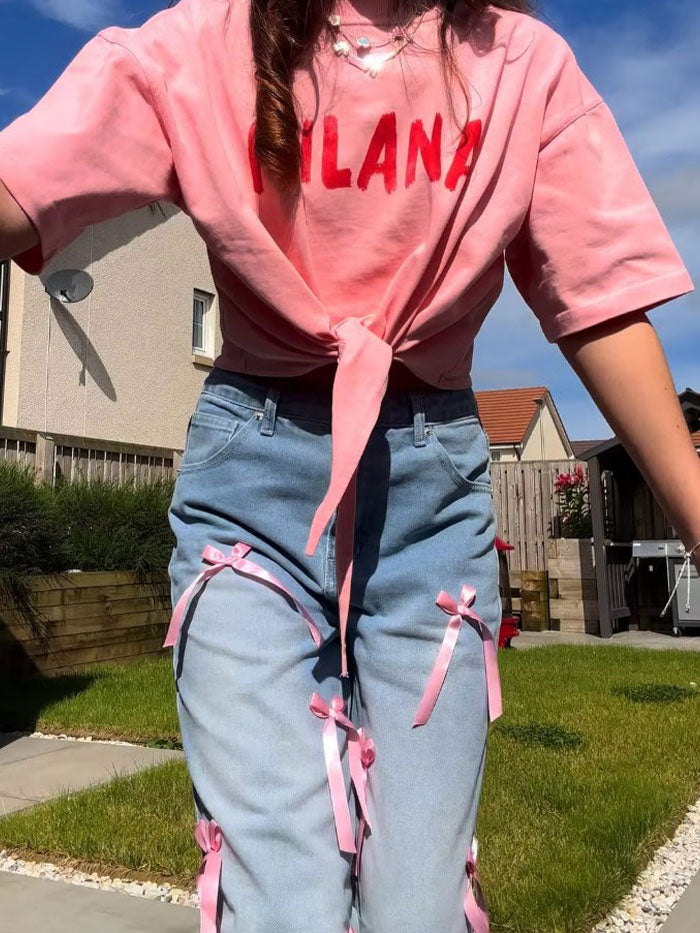 Chic outfit featuring a pink ribbon accessory styled with denim.