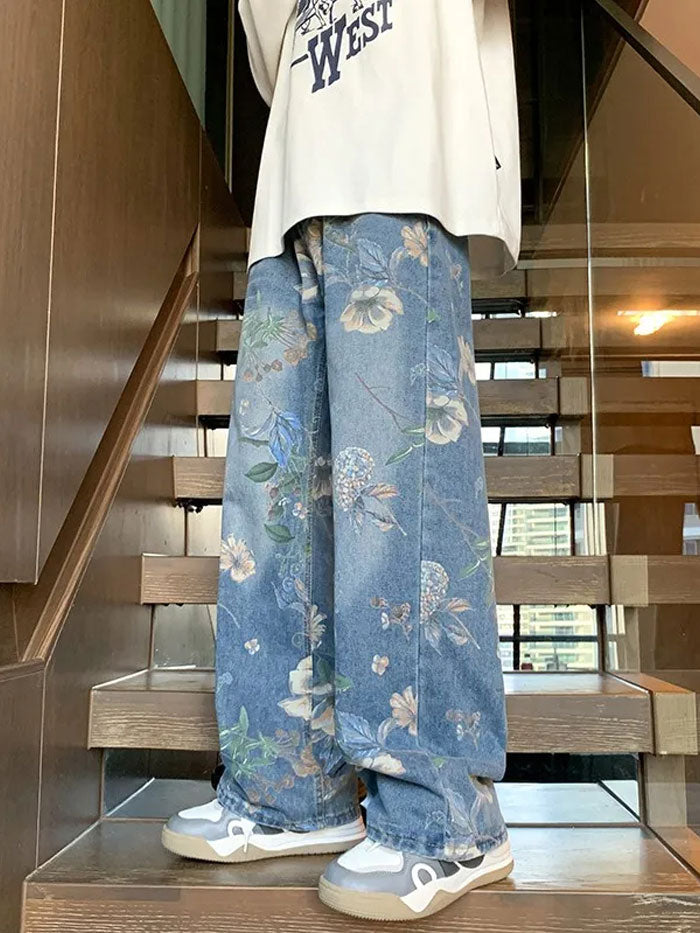 Person wearing wide-leg floral print jeans sitting on stairs