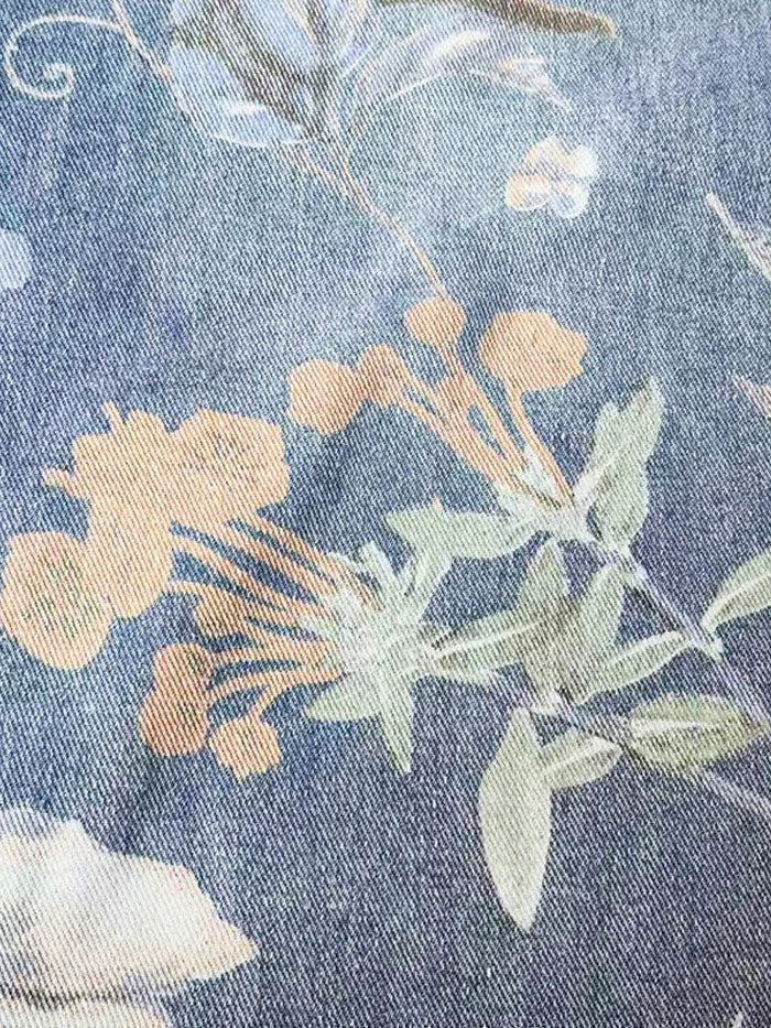 Front view of floral embroidered jeans highlighting relaxed fit and streetwear aesthetic.