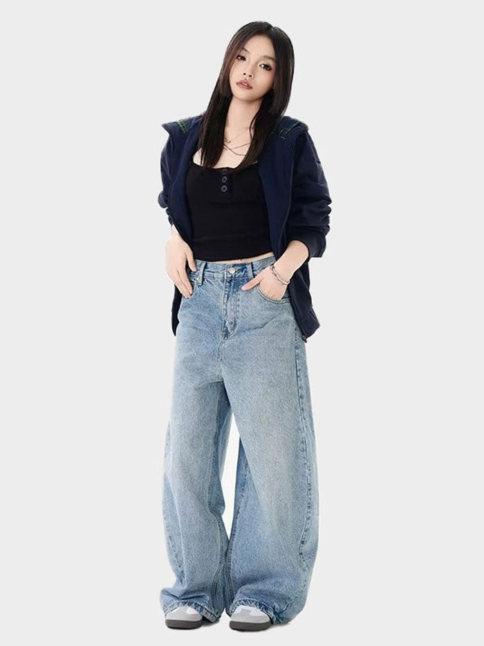Oversized baggy jeans styled in a casual street fashion outfit, paired with a fitted top and jacket.