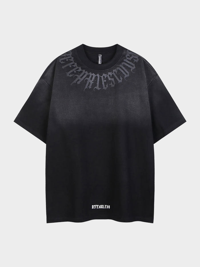 Black front view of oversized ombré t-shirt featuring gothic neck lettering and "Be Fearless" hem text