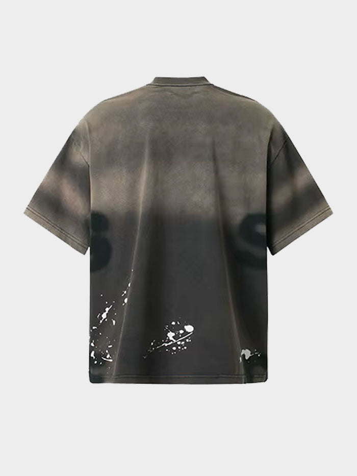 Back view of black oversized graffiti T-shirt with abstract spray paint details and grunge effect