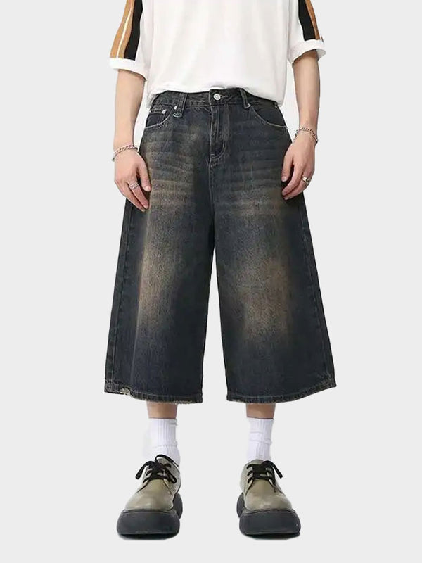 Front view of Looseywear wide-leg denim shorts with faded wash and knee-length cut.