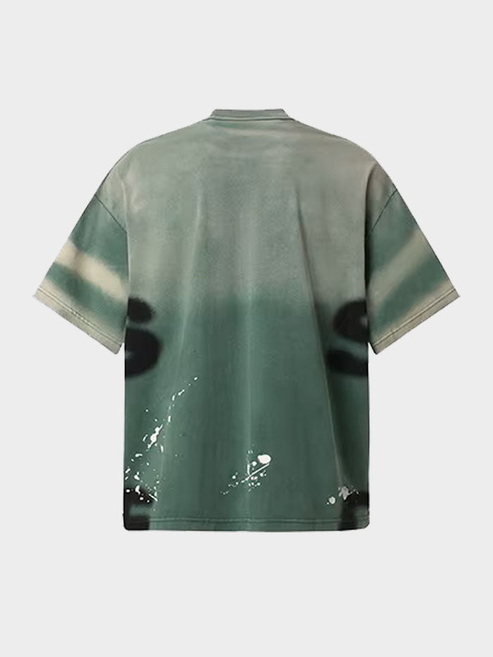 Back of green street style T-shirt with bold grunge paint effects and urban flair