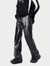 Men's shiny black leather pants styled with athletic top and sneakers