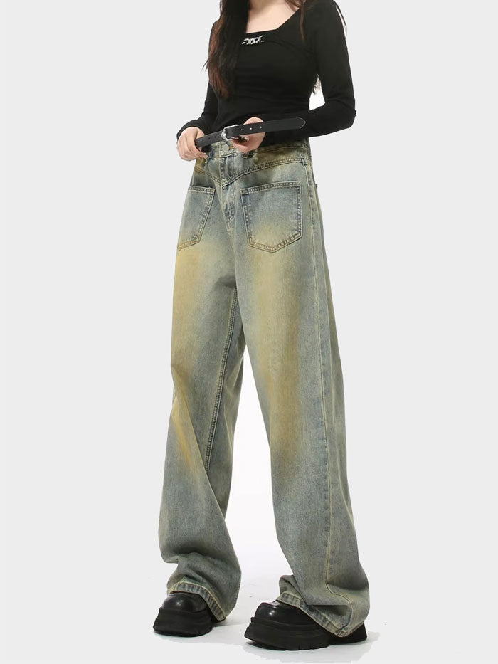 Woman wearing high-rise light-wash wide-leg jeans styled with a black fitted top and platform shoes.