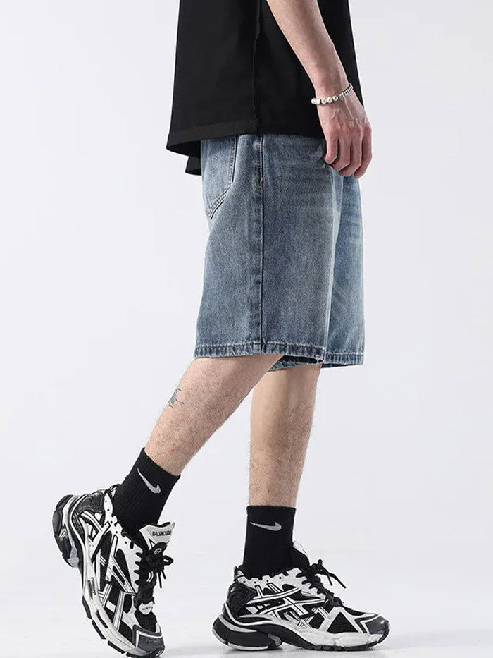 Full outfit showcasing faded denim Bermuda shorts and Balenciaga sneakers