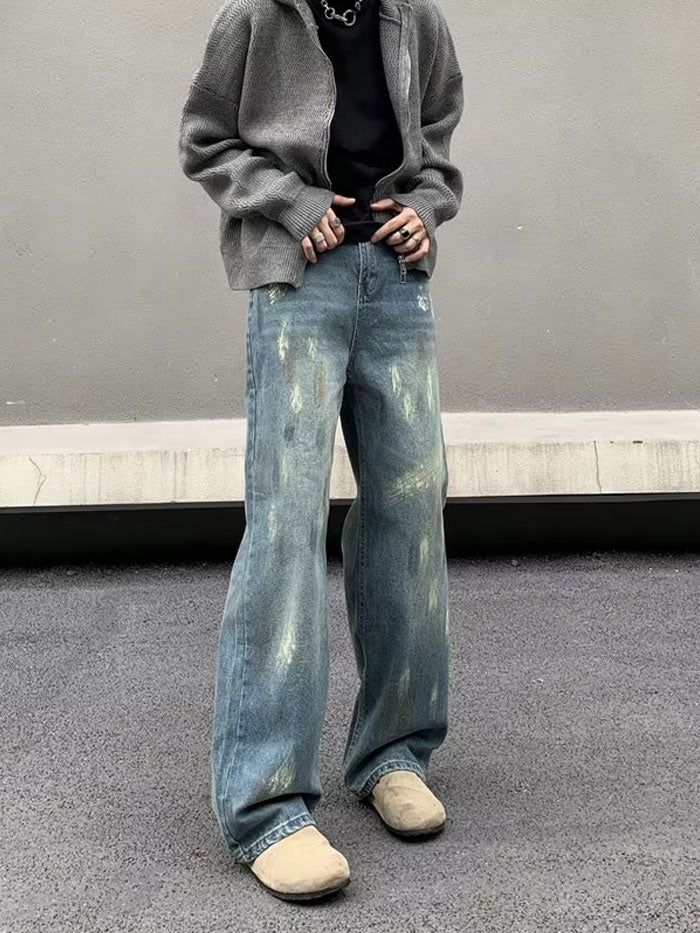 Loose fit jeans worn with layered top and casual accessories.