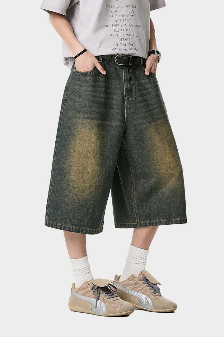 Waist fit and Calvin Klein waistband visible under washed denim shorts