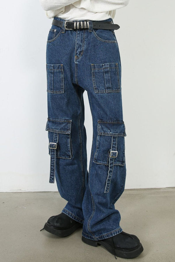 Front view of model wearing wide-leg cargo jeans with utility pockets and belt