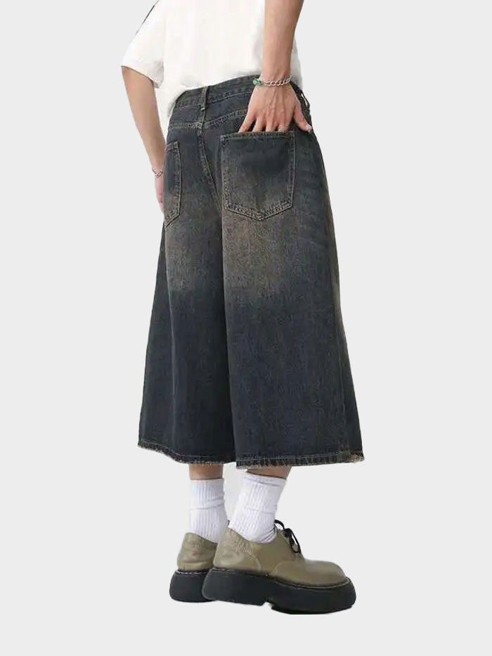 Wide-leg knee-length denim pants styled with streetwear sneakers and socks.