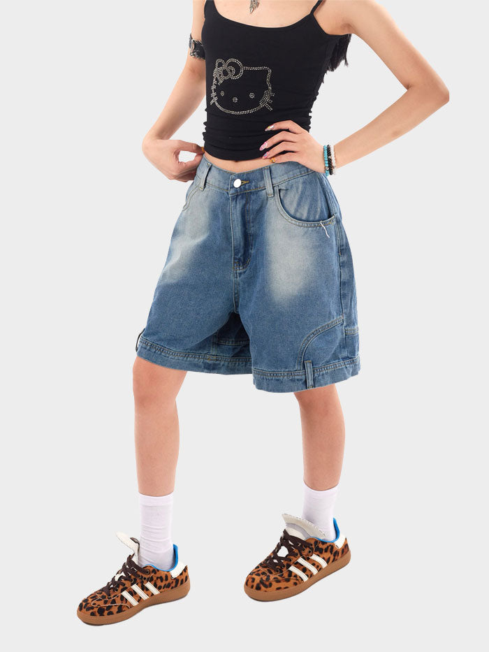 Front view of black denim shorts with yellow top-stitching detail.