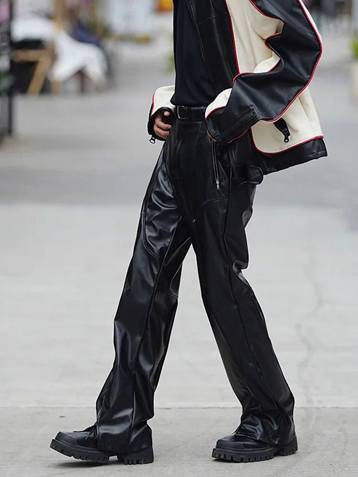 Slim-fit black leather pants in motion on urban sidewalk