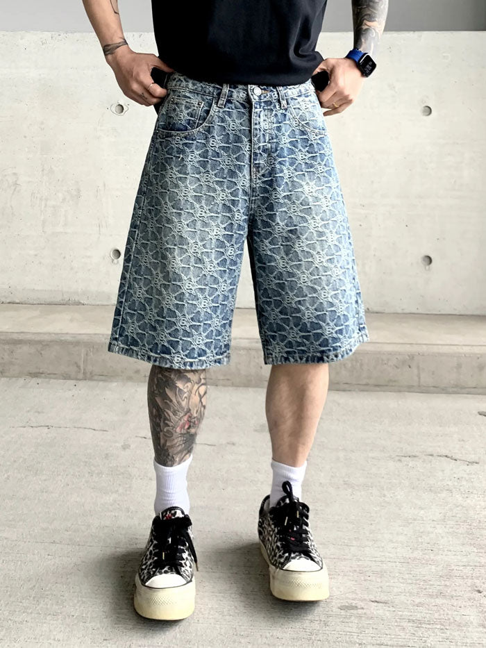 Man wearing back view of loose-fit designer denim Bermuda shorts with vintage logo print.