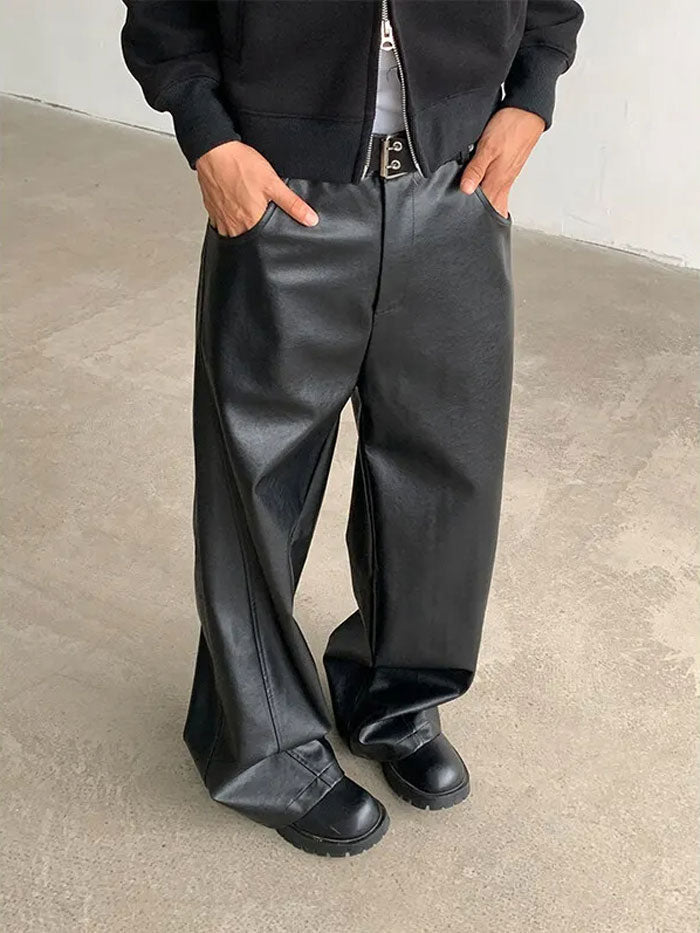 Men's wide leg leather pants in black styled for streetwear fashion.