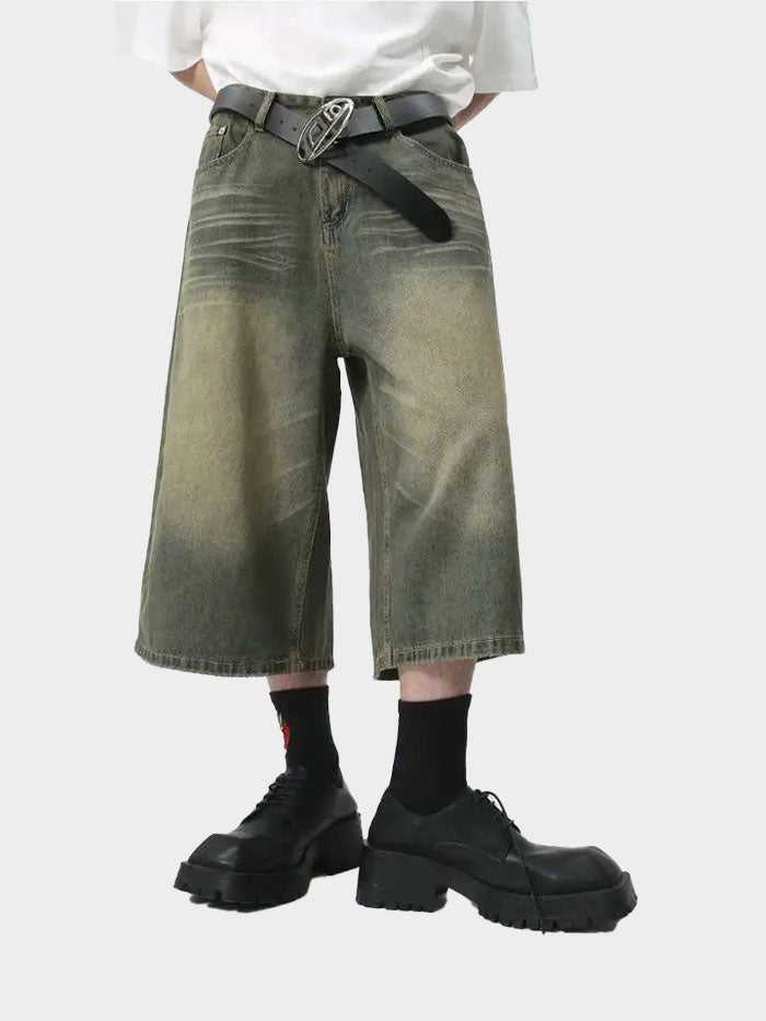 Full front view of model in loose olive green vintage denim shorts