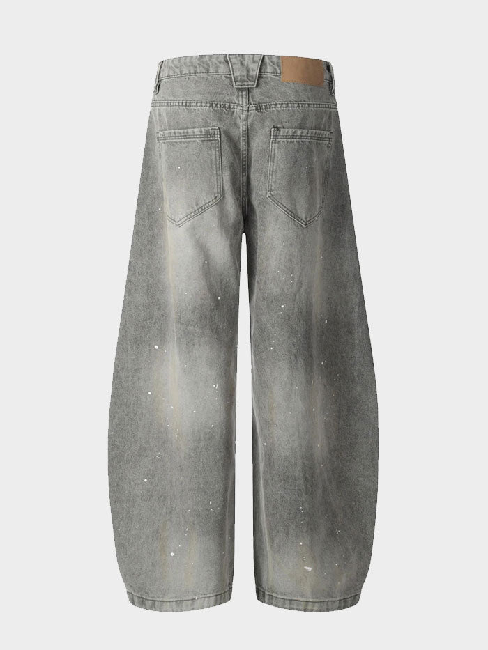 Rear view of model showcasing oversized faded grey jeans with a casual streetwear look.