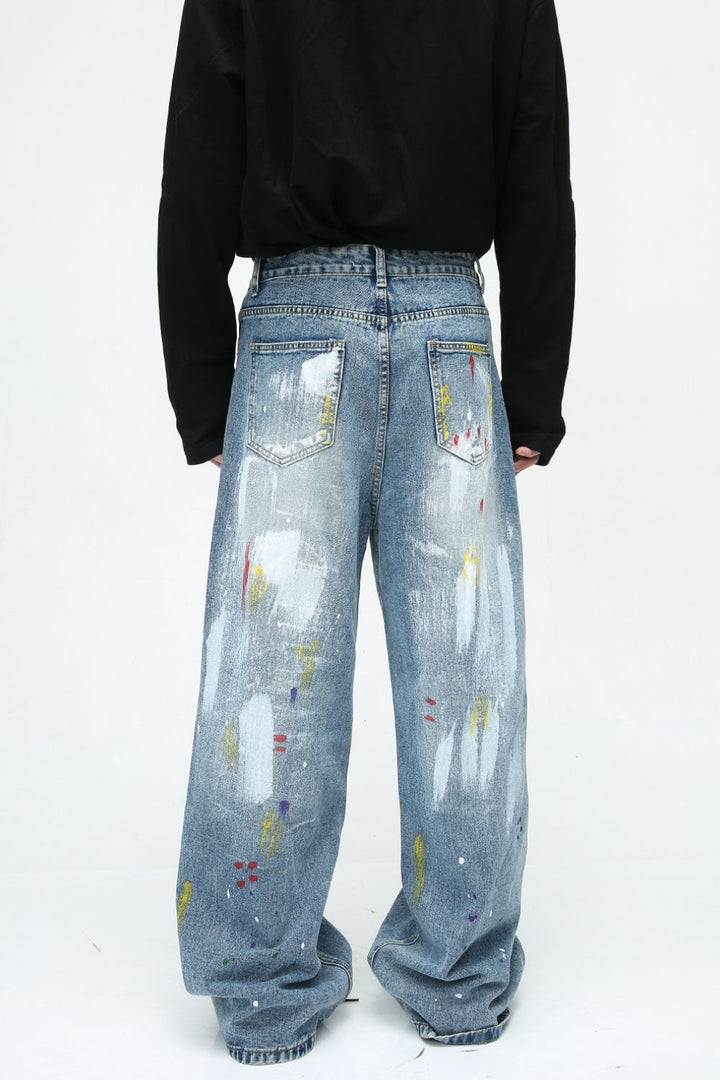 Rear view of wide-leg jeans with heavy paint effect and back pockets