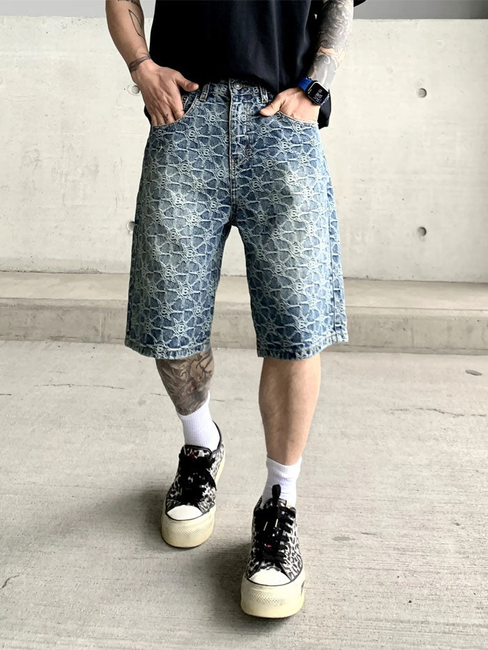 Model showcasing side angle of men’s washed denim shorts with casual street style look.