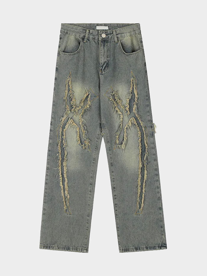High-waisted fringe jeans in distressed denim with urban streetwear style.