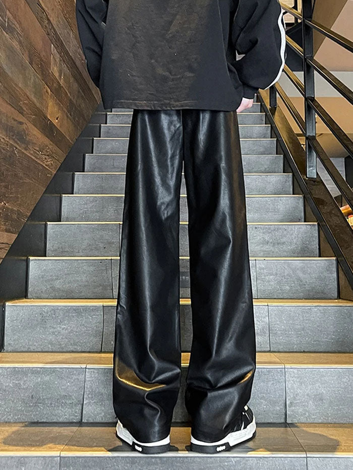 Close-up of urban black leather pants featuring cargo pockets.