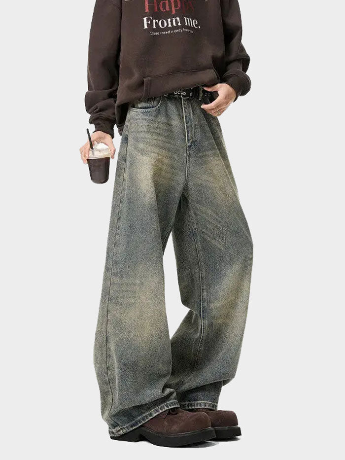 Close-up of vintage wide-leg jeans with rugged finish – high waist and loose fit.