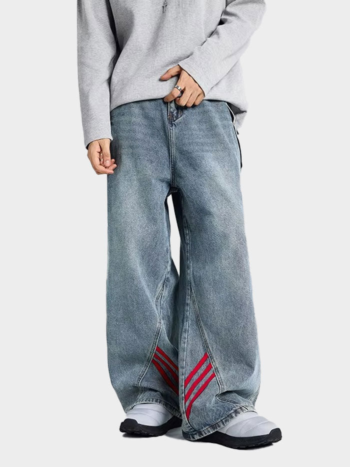 Rear view of unisex wide-leg denim pants with red stripe accents running down the back side.