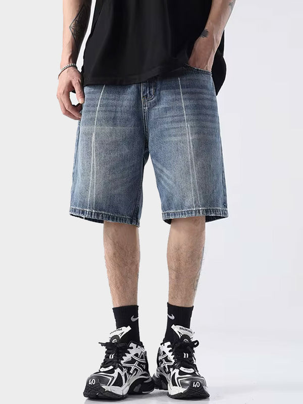 Man wearing vintage wash denim Bermuda shorts with sneakers – front view