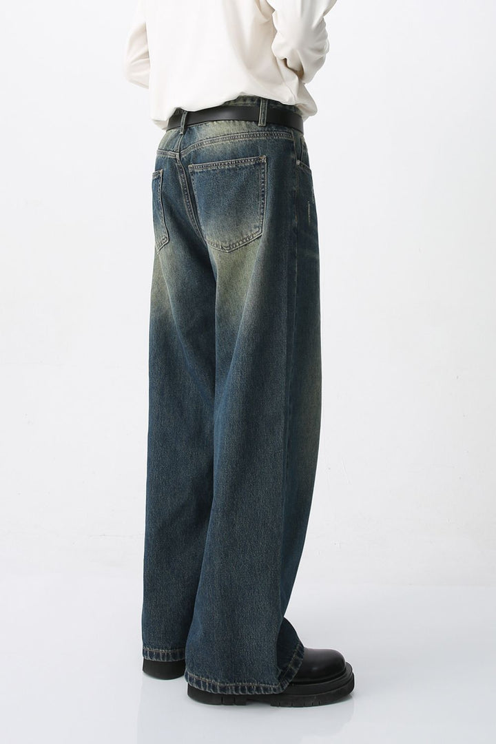 Rear view of vintage-inspired wide-leg jeans showing back pocket placement and wash texture.
