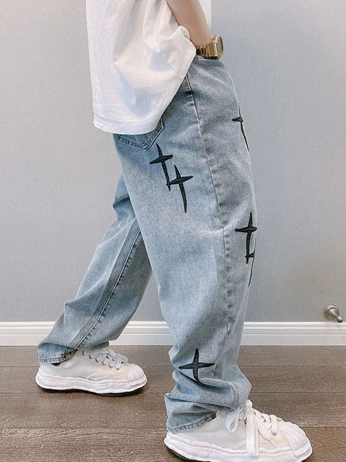 Model in walking pose wearing oversized urban jeans with stitched cross details