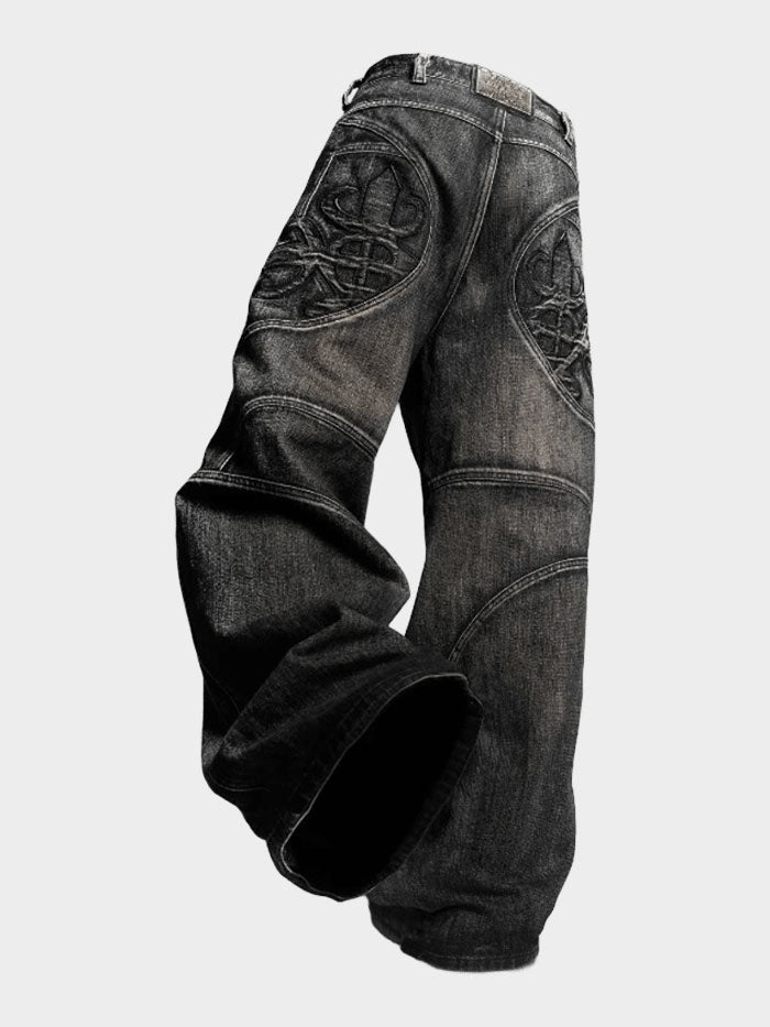 Digitally edited black wide-leg jeans with gothic embroidery floating against a clean transparent background.